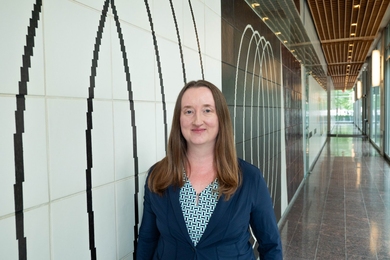 Mary Ellen Wiltrout stands in an empty hallway