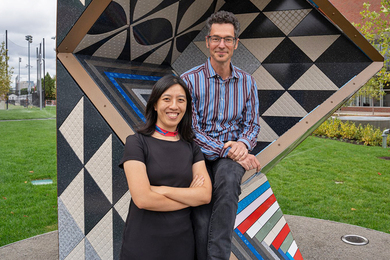 fusion reaction research paper Anna Huang and Eran Egozy pose by an outdoor geometric sculpture