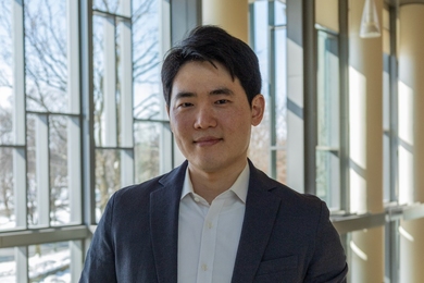 Sojun Park poses in a sunlit corridor