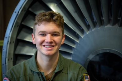 Brian Robinson in front of a large turbine engine