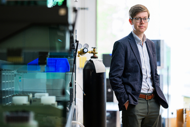 Connor Coley standing in the lab