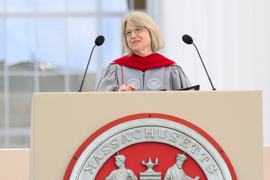 Sally Kornbluth speaks at podium on stage.