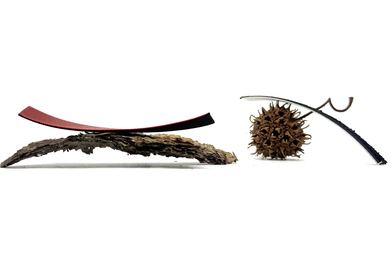 Tree bark and a sweetgum seedpod are next to thin, 3D-printed strips that bend.