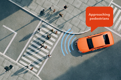 A car senses the people on a crosswalk and says, “approaching pedestrians.”