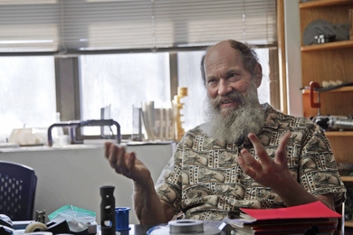 Alex Slocum, wearing a “men et manus” shirt with a repeating beaver pattern