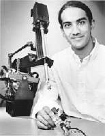 Seattle, WA native Akhil Madhani, 29, winner of the 1998 Lemelson-MIT Student Prize of $30,000 for inventiveness, holds one of his inventions, the Black Falcon, a teleoperated robot for minimally invasive surgery.