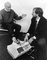 Professor George Pratt (left) demonstrates the sonometer, a device he invented to measure bone density, with Kevin Wilson (Ph.D '85), who works for Hologics, the company manufacturing the device.