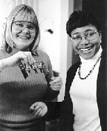 Assistant Professor Paula Hammond (right) and graduate student Sarah Clark are developing a new way to create microscopic patterns on surfaces. They recently mechanized the process; Ms. Clark holds part of the equipment to do so.