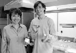 Professor Dorothy Hosler holds a jar of latex taken from trees while undergraduate Michael Tarkanian holds a vial of juice from crushed morning glory vines and a small rubber ball made by combining the other two.