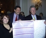 Professor Eric Lander (center), director of the Whitehead/MIT Center for Genome Research, and Lauren Linton, co-director of the Genome Center's sequencing center, presented President Clinton with a printout of human DNA sequence trace signed by all the Genome Center members.