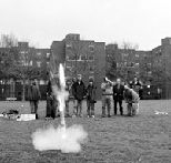 In another Freshman Advising Seminar, "Building a Rocket-Deployed Rover," Dr. James Bales of electrical engineering and computer science videotapes a stduent rocket splititng in two upon takeoff during launch at Briggs Field.