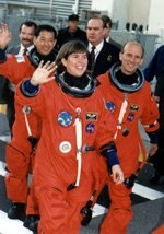 Astronaut Janice Voss walks out of the crew quarters at the Kennedy Space Center on the morning of the launch of STS-99, accompanied by Mamoru Mohri (left) of the Japanese space agency (NASDA) and Gerhard Thiele of the European Space Agency (ESA).