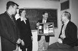 Astronaut and MIT alumnus John Grunsfeld, holding a framed collection of MIT flags he took into space with him, talks about his flights with UROP assistant director Michael Bergren (left), UROP program assistant Melissa Martin, and Professor Kim Vandiver (far right), director of the Edgerton Center and dean for undergraduate research.