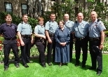Campus Police officers and a paramedic joined Mrs. Becky Vest at the President's House last week to receive commendations for saving her life. Left to right: paramedic Chris Wozney, Officer Michael E. Carey, Sgt. Janet Popp, Officer Mark R. Kelleher, Mrs. Vest, and Officers Michael R. DeBenedictis, Kevin M. O'Connor and Brent J. Nelson.
