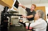 Dan Doherty, a physical therapist at Spaulding Rehabilitation Hospital, helps Frances Heimberg work with MIT-Manus during her rehabilitation therapy following a stroke.