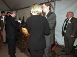 Richard P. Simmons, retired head of metals manufacturer Allegheny Technologies, familiarly wields a plasma arc cutter to slice through the loops of a two-foot bow and stainless steel ribbon at the "ribbon-cutting" for Simmons Hall. Holding the ribbon at each end are (left) his daughter Amy and her husband Sean Sebastian, and (right) his son Brian and his wife, Julie Simmons.