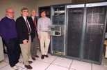 Standing by a cluster of powerful computers to be used in an MIT/Compaq collaboration are (left to right) Richard Brower, professor of physics at Boston University; Patrick Dreher, research scientist and associate director of the Laboratory for Nuclear Science; John Negele, professor of physics at MIT; and research scientist Andrew Pochinsky.