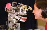 Dr. Cynthia Breazeal plays with Kismet, the robot that mimics and responds to human emotions.