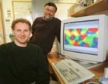 Valentin Dragoi, a postdoctoral fellow in brain and cognitive sciences, (seated) and Professor Mriganka Sur show an image of neural pinwheels on their computer monitor.