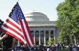 A student displays the American flag at a gathering of thousands of MIT community members on Killian Court last Wednesday.