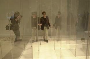 A photographer snaps away as artist Yoko Ono makes her way through a maze that's part of the "YES Yoko Ono" exhibit now showing at the List Visual Arts Center.