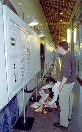 John Albeck, a graduate student in cellular biology, and Suzanne Gaudet,        a postdoctoral fellow in biology, prepared for the poster competition at        the symposium held in honor of MIT's new BioMicro Center (see MIT        Tech Talk, Jan. 9 ). The Jan. 11 symposium, "Computational and Systems Biology: From Biofabrication to Bioinformatics," was the first of what will become an annual eve...