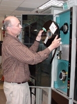 Dr. Alan Whitney of Haystack mounts an 18,000-foot tape on the Mark IV correlator. Magnetic tapes will be eliminated when the e-VLBI program is finished.
