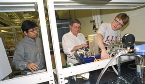 Left to right: Rubaiyat Amin Kahn, Professor Clark Colton and Richard West work with the heat exchanger in a chemical engineering lab. The machine can also be controlled remotely over the web.