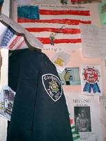 The art in the background represents a fraction of the work sent by thousands of children to the Ground Zero workers, covering almost every inch of space--even the backs of pews--inside St. Paul's Chapel. The jacket was left by one of the many firefighters from Cambridge who was part of the recovery team.
