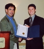 Professor Edward Crawley (left), head of aeronautics and astronautics, presents the David J. Shapiro Award to junior Ryan K. Owen.