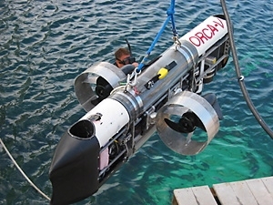 The six-foot-long ORCA-V has two main thrusters at the side and two vertical thrusters at the bow and stern. There are two main dry compartments in the sub; the top one contains a computer that controls the sub, while the bottom one contains the batteries and the motor drivers.