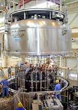 This 150-ton magnet in Japan is crucial to an international experiment on nuclear fusion (a cover is held above it, ready to be put in place for a test run). Image courtesy Japan Atomic Energy Research Institute