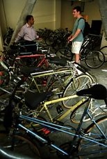 Graduate students Sham Sokka (left) and Chris Cassa chat in the bike room at the new graduate dorm at 70 Pacific St. Students can rent bikes for $1 a day or store their own bikes there.