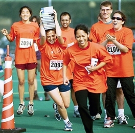 Johnson Games competitors take a shot at "The Balancing Act" on        Saturday. Participants loaded books one-by-one onto their heads, ran a short        distance and then passed them to the next member of their team.