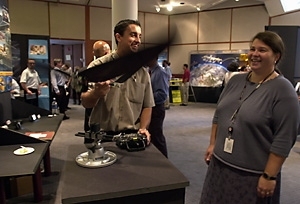 George Costa (S.B. 2000) shows fellow alumnus Jamie Anderson (S.M. 1992, Ph.D.) the ornithopter he's working on at Draper Lab at the last week's Tech Expo.
