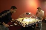 Dave Milanes (left), a graduate student in aeronautics and astronautics, and Dan Kirk, a postdoctoral associate in aero/astro, get into a game of table hockey in the new game room in the Stratton Student Center.