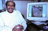 Professor Elfatih Eltahir of civil and environmental engineering sits by a monitor showing rock art of a giraffe carved thousands of years ago when portions of the Sahara were still green.