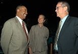 MIT News Office Director Arthur Jones (left) exchanges pleasantries with Vice President Kathryn A. Willmore and President Charles M. Vest at the freshman convocation on Aug. 25, 2003.