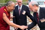 The Dalai Lama, left, is greeted by MIT President Charles M. Vest, center, and Phillip A. Sharp, director of the McGovern Institute for Brain Research at MIT, which co-sponsored the event with the Mind and Life Institute.