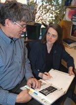 Professor David E. Housman of biology, left, and Amanda Shearman, research scientist in the Center for Cancer Research, discuss some of the images they use in their work with gene variation and cardiovascular disease.