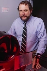 Stephen Benton in his MIT Laboratory in 1998, with an early holovideo apparatus.