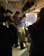 More than 26 researchers, students and administrators with the China Central Television crew, including Nobel laureate Wolfgang Ketterle (left center), who gave a tour of his lab with graduate student Dan Miller (right center).