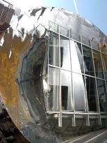 Two of the hallmark design elements of the Stata Center: a polished surface and, in its reflection, an irregularly shaped exterior wall.