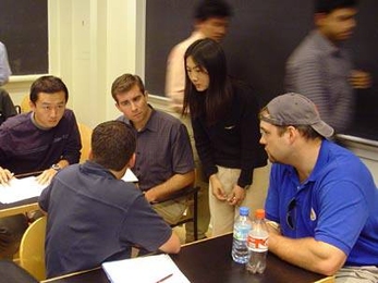 Members of the Fuel Cell Breakthrough i-Team plan their strategy. From left, Jin Yi; Brett Prince  (with back to camera); Matt Ziskin;, principal investigator Yang Shao-Horn, professor of mechanical engineering; and Jeff Baer.
