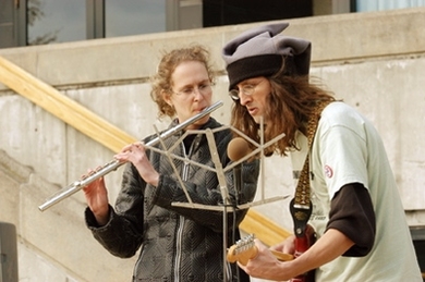 Guitarist Martin Hunter (right) and flutist Alison Hearn play at the rally organized by the MIT Free Radicals held at the Student Center.