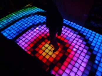 A dancer tests his disco moves on the new East Campus lounge floor.