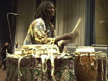 MIT resident artist and master Senegalese drummer Lamine TourÌ© will help lead 11 members of the musical group Rambax on a study tour of Senegal starting May 23. He is shown playing with Rambax, which performs Senegalese music.