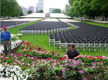 Rob Lyons, left, and Kathy Coletti, gardeners in MIT's Department of Facilities, plant flowers in preparation for MIT's Commencement exercises on June 3.