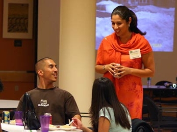 Robert Tostado, from San Diego State University, chats with Brittanya Murillo, a current MIT graduate student in the Department of Urban Studies and Planning, at the opening session of Converge 2005 at MIT. The weekend event is meant to introduce potential graduate students to MIT who may not have otherwise considered applying. <a onclick="MM_openBrWindow('converge-1-enlarged.html','','width=509, ...