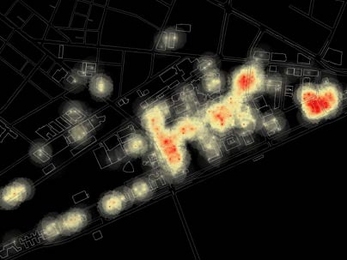 A screenshot from an animation showing the changing patterns of  wireless Internet activity during 24 hours on the MIT campus. Red indicates a large number of users per access point, black a small number.